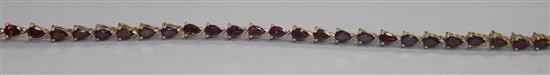 A 9ct gold and garnet set line bracelet, 19cm approx.